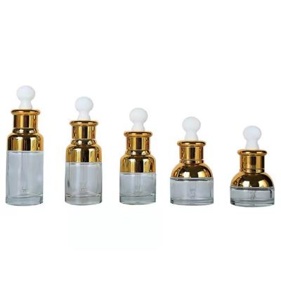 China 20ml Cosmetic Ruler 30ml 50ml Round Perfume Emulsion Gold Cap Bottle Essential Oil Transparent Glass Dropper Bottle for sale