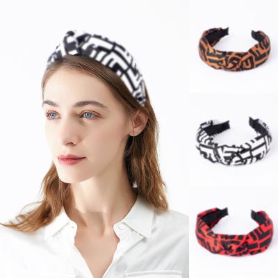 China Friendly material fashion face wash headband soft wide brim retro cross knotted luxury headband ladies headband for sale