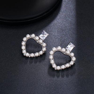 China FASHIONABLE Luminous Cube Zircon Inlaid White Pearls With Heart Design Hollow Stud Earrings For Women's Earrings for sale