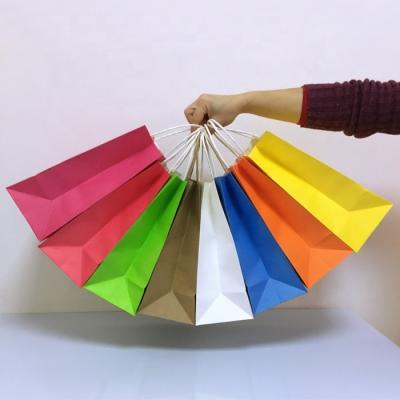 China Recycled Materials Custom Color Printing Kraft White Paper Bags Shop Shopping Clothing Paper Tote Bags Cheap Universal Paper Bags for sale