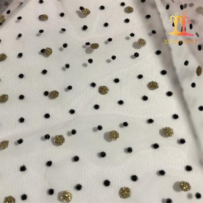 China Viable Wholesale Cheap Shiny Glitter Gold And Spots Black Flocking Tulle Lace Fabric For Skirt for sale