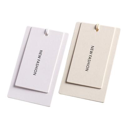 China Simple Elegant Recyled And White Color 125gsm Paper Garment Hanger Craft Color Card Clothes Hanger Tag for sale