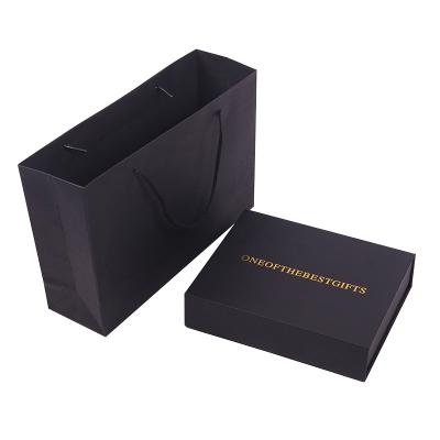 China Customization Garment Retrievable Matte Rigid Book Shape Magnetic Black Embossed Gold Foil Gift Folding Box With Insert for sale