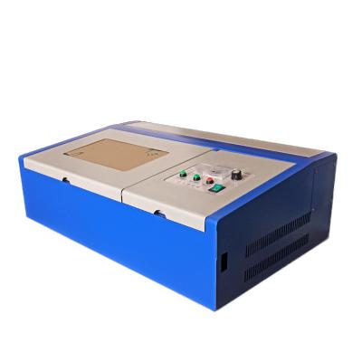 China Laser Engraving Smaller Size Portable Laser Cutting Machines CO2 3020 Mini Laser Engraving Cutter for sale