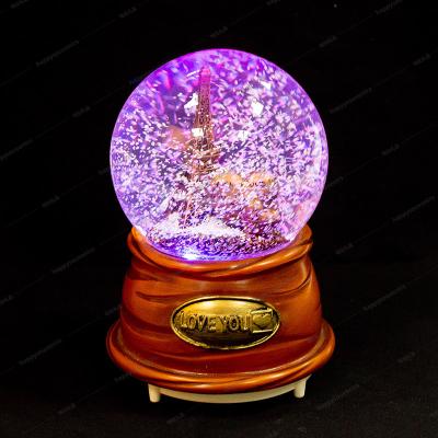 China Colorful Europe Light And Music Snow Globe With Paris Building Custom Resin Water Ball for sale