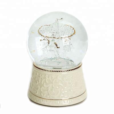 China Europe Lighted Snow Ceramic Base Globe, Music And Carousel Wonderful Wedding Crystal Snow Globe 100mm Gifts For Guests for sale