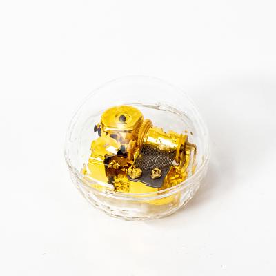 China Custom Crystal Transparent Gold Round Acrylic Wind-Up Music Box for sale