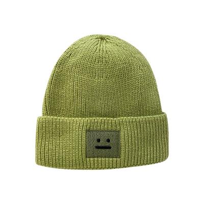 China COMMON Wholesale Women Thicken Winter Warm Skull Ski Hat Plain Solid Color Smile Beanies Slapped Patch Knitted Smile Beanie for sale