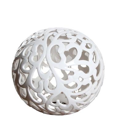 China Modern Nordic home interior decoration decor ball shape hollowed- out small ceramic gift craft table decoration centerpieces all hand carved for sale