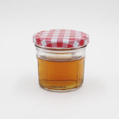 China 250ml canned food glass jam jars for clear glasses, honey jars for sale, caviar package bottles with metal lily Te koop