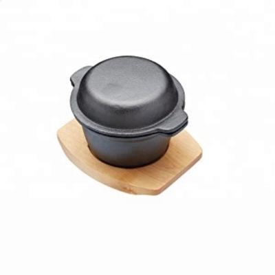 China Sustainable Cast Iron Mini Cooking Pot with Wooden Lid and Base for sale