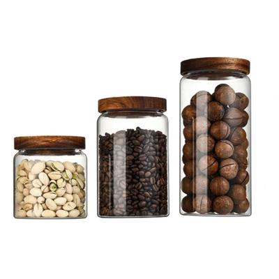 China Hot Sale 500ml 850ml 1250ml Borosilicate Glass Clear Sealed Clear Sealed Storage Jar Coffee Nut Food Storage Jar With Acacia Lids for sale