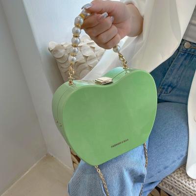 China 2021 Hot Selling Motion Sensing Heart Ladies Clip Solid PVC Jelly Handbags Women Shoulder Pearl Shoulder Bag Cross Chain Top Candy Color for sale