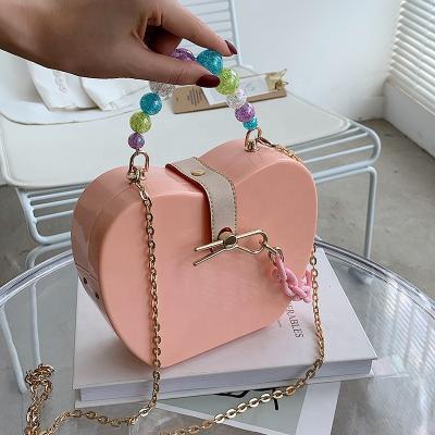 China Women's Luxury Lady Solid Color One Shoulder Shape RFID Apple Clip Backpack Cross Chain PVC Pearl Handle Handbag SummerJelly Bags for sale