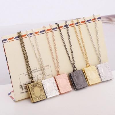 China Wholesale Bohemia China Islamic Design Book Shape Can Open Alloy Picture Frame Necklace for sale