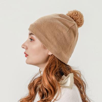 China COMMON Wholesale Blank Winter Hat Women Camel Knit Beanie Hats With Pom Pom for sale