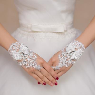 China Wedding yuan women short white pearl wedding gloves lady bow tie performance party bridal gloves for sale