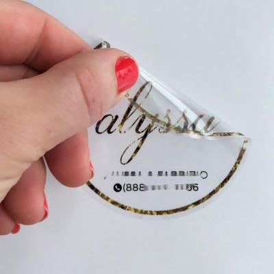 China Custom Adhesive Waterproof Private Cosmetic Clear Bottle Sticker Roll Up Transparent Gold Foil Logo Sticker Printing Hot Stamping Labels for sale