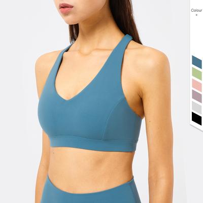 China Wirefree Logo Crop Top V-Neckline Sports Bras Nude Padded Yoga Antibacterial Custom Running Workout Sports Bras for sale