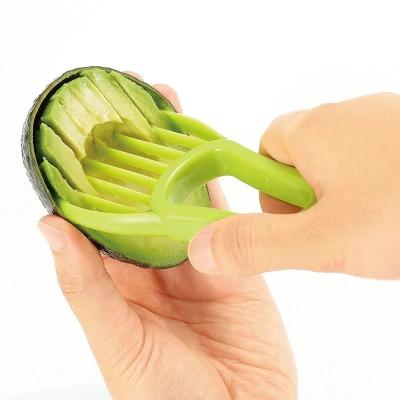 China Knife Kitchen Vegetable and Fruit Tools Creative Three in One Plastic Avocado Slicer Shea Butter Peeler Cutter Knife Kitchen Vegetable and Fruit Tools for sale