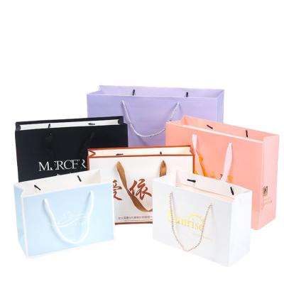 China Recycled Materials Paper Bag Manufacturers Wholesale Reusable Gift Packaging Shopping Bag Luxury Custom Paper Bag for sale