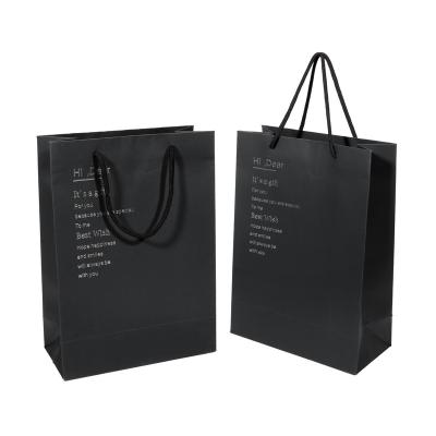 China Recyclable Custom Logo Printed Black Cardboard Paper Gift Bag For Garment Shopping Packaging for sale