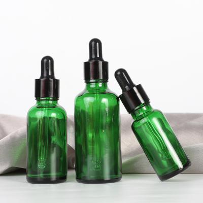 China Skin care cream 100ml cylinder empty dropper green glass jar for face perfume and oil or body liquid lotion for sale