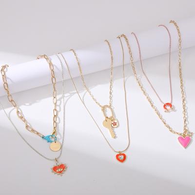 China Lead Free Nickel Free Women Trending Jewelry Gold Plated Pink Enamel Heart Pendant Necklace Chain Lock and Key Necklace for sale