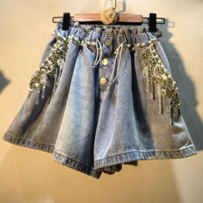 China Anti-Wrinkle New Summer Light Blue Tassel Beaded Denim Shorts Diamond-Embedded Waist High Slimming Women's Wide-Leg Denim Abbreviations for sale