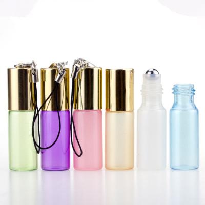 China 3ml 5ml Pearl Color Glass Cosmetic Roll On Pendant Bottles With Gold Cap Metal Ball Head Chain Perfume / Essential Oil Bottle for sale