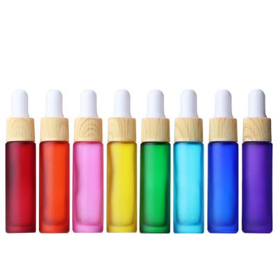 China 10ml Gradient/Shade Matte Rainbow Cosmetic Glass Dropper Bottle With Wood Grain Cap Perfume/Essential Oil Bottle for sale