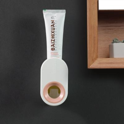 China Sustainable Adhesive Wall Mounted Automatic Toothbrush Holder Wall Suction Toothpaste Squeezer for sale