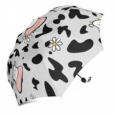 China New Back Gear Items In Market Black And White Cow Printing Cheap Fold Umbrella For Rain for sale