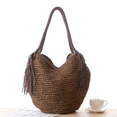 China New Straw Woven Handbag Simple Braided Waterproof Tassel Bag Single Shoulder Beach Bucket Woman Bag For Women for sale