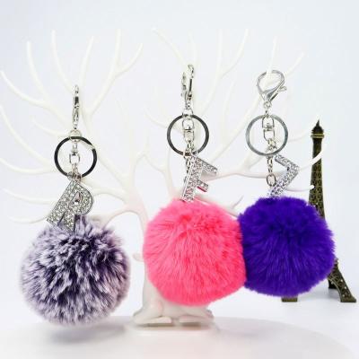 China Promotion Gift Metal Key Chains Pom Pom Initial Letter A-Z Cute Puff Fur Ball Accessories Sparkle Metal Initial Keychains for Women and Girls for sale