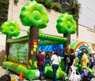 China Outdoor Entertainment Party Jumpers Bounce House Kids Bouncy Castle With Slide Jungle Tree Inflatable Amusement Park for sale