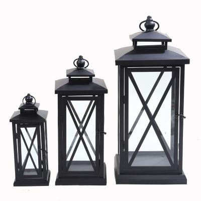 China Factory direct sales home decoration candlestick minimalist wrought iron candle lantern outdoor windproof home glass storm for sale