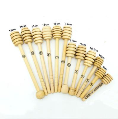 China Hot Selling Custom Stocked Logo Olive Wood Wooden Jam Jar Honey Spoon Honey Dipper Honey Stick for sale