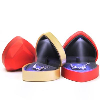 China Fashion PU Velvet Jewelry Box LED Light Leather Creative Heart Shaped Necklace Pendant Pendant Jewelry Box In Stock Custom Logo for sale