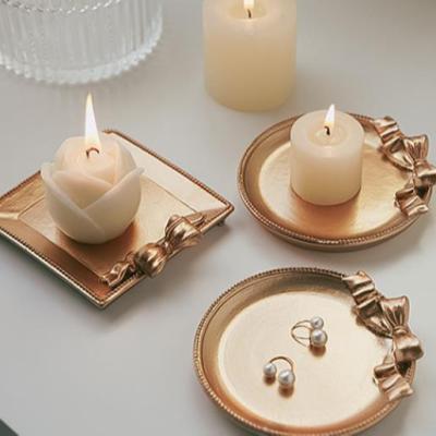 China Retro home gold color creative design bowknot resin decoration candle tray for sale