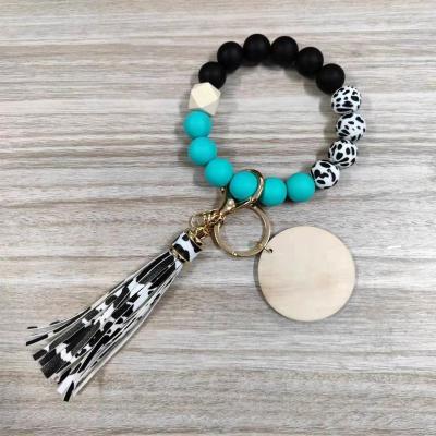 China Custom Fashiontable PU Leather Tassel Cow Print Silicon Beads Bracelet Key Chain for sale