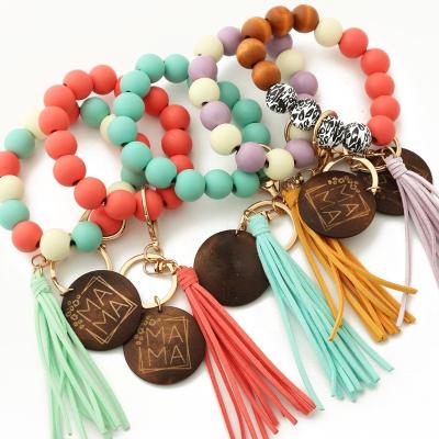 China Fashiontable Custom Wooden Disc Wood Beaded Suede Tassel Bracelet Key Chain for sale