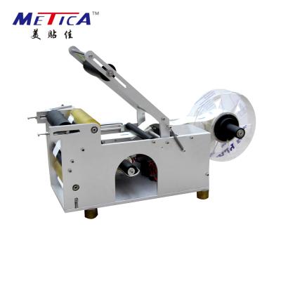 China Semi-automatic food round bottle labeling machine and manual plastic labeler for sale