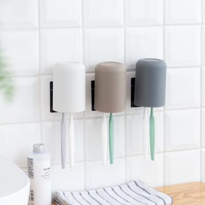 China Viable Wall Mounted Plastic Toothbrush Cup Holder Bestselling Punchless Toothbrush Holder for sale