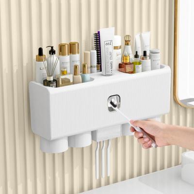 China Viable Creative Fashion Toothpaste Dispenser Wall Storage Toothbrush Multifunctional Plastic Automatic Toothpaste Holder for sale