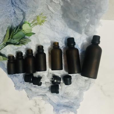 China Free Sample High Quality Matte Black Coating Glass Dropper Bottle Essential Oil Bottle With Gold Dropper Cap for sale