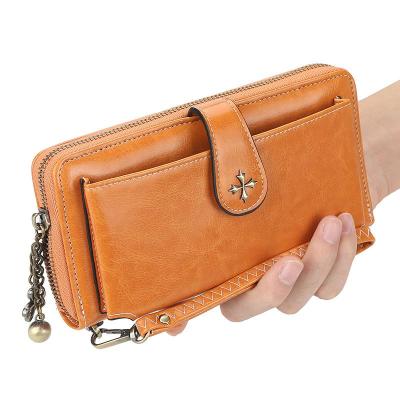 China Waterproof Hot Leather Tassel Buckle Wax Oil Wallet Zipper Mini Wallets For Women Leather Fashionable for sale