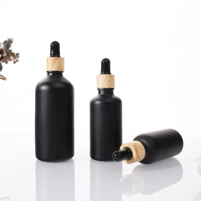 China Cosmetic Essential Oil Bottle Glass Black Frosted Essential Grain Essential Wood Dropper Bottle for sale