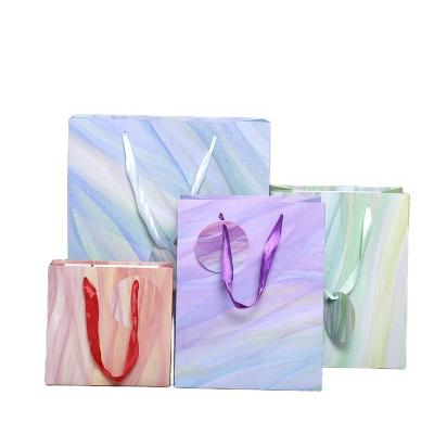 China Recyclable Packaging Bags For Clothes Kraft Paper Sack Paper Bag With Ribbon Handle for sale