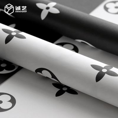 China Latest Product Waterproof Black White Aristocratic Flower Bouquet Wrapping Paper Gift Wrapping Paper for sale